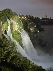a waterfall on the side of a river at night at Düden Dream in Antalya