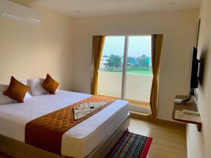Letto o letti in una camera di Hotel Ramakrishna