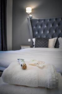 a hotel room with a bed with a roll on it at Dallure Boutique Brasov in Braşov