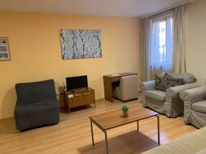 a living room with a couch and a table at Villa Park Apartment nr 216 in Borovets