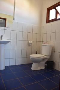 a bathroom with a toilet and a sink at Centre Lucien Botovasoa in Antsiranana