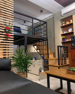 a living room with a spiral staircase and a table at JORA LOFT- modern industrial apartment 1-A in Dagupan