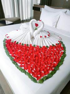 two swans in a heart of roses on a bed at Tuyet Son Hotel (TS Ocean Hotel) in Da Nang