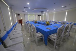 a long table with white chairs and a blue table cloth at Tuyet Son Hotel (TS Ocean Hotel) in Da Nang