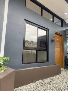 a blue building with a window and a door at JORA LOFT- modern industrial apartment 1-A in Dagupan