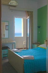 Ένα ή περισσότερα κρεβάτια σε δωμάτιο στο Mirtos Hotel