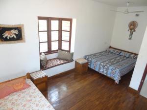 a room with two beds and two windows at Montecello in Trivandrum