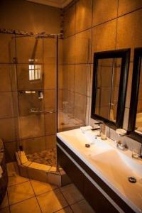 La salle de bains est pourvue d'un lavabo et d'une douche. dans l'établissement Critchley Hackle, à Dullstroom