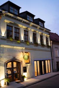 a white building with a sign on the side of it at Hotel Pod Zamkem in Velké Meziříčí