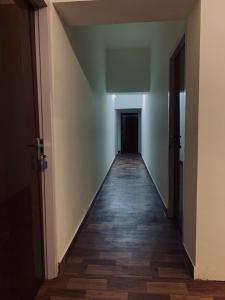 an empty hallway with a hallway leading to a door at Casilda By The Oaks Inn in Ernakulam