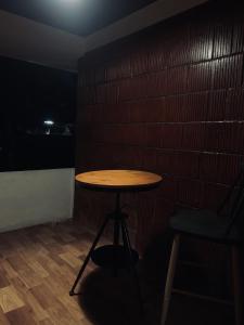 a small table in a room with a brick wall at Casilda By The Oaks Inn in Ernakulam