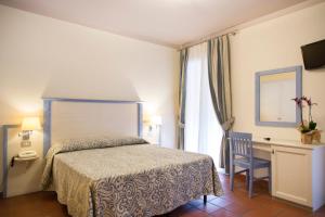Postel nebo postele na pokoji v ubytování Blu Hotel Laconia Village