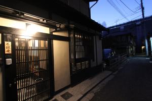 a building with a gate on the side of a street at Brian Private Machiya in Higashiyama in Kyoto
