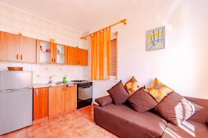 a living room with a couch and a kitchen at Siriščević Apartment in Korčula