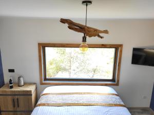 - une chambre avec un lit et une grande fenêtre dans l'établissement Villa Occitana, à Calvisson