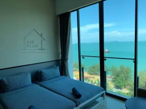 a room with two beds in front of a large window at PD D'Wharf Premium Suite - Full Seaview (Up to 6 Pax) in Port Dickson