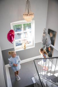 a little girl standing in a room with balloons at Boutiquehotel Petuh in Flensburg