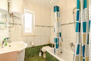 a bathroom with a sink and a toilet at Siriščević Apartment in Korčula +36 photos