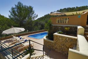 a villa with a swimming pool and a house at Villa Magdalena in Calvia Town