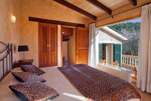 a leopard print bed in a bedroom with a balcony at Villa Magdalena in Calvia Town +31 photos