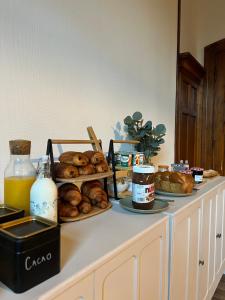 a counter with various types of pastries and bread on it at O'Cottage double in Annonay