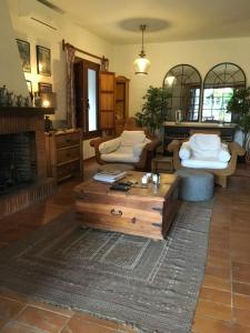 a living room with a couch and a coffee table at Las Gitanillas, villa with heated pool, La Cala de Mijas in Mijas Costa