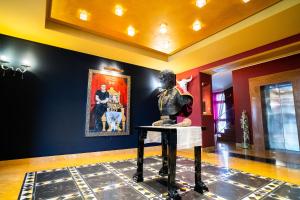 a statue of a man sitting on a table in a room at Marcantonio Hotel in Giugliano in Campania