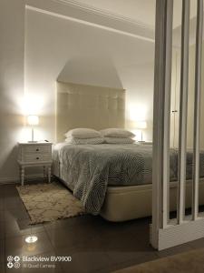 a bedroom with a bed and a nightstand with two lamps at Oporto apartment Batalha in Porto