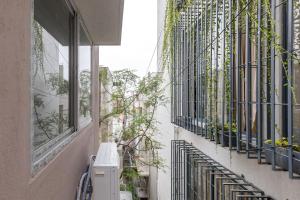 a building with windows and plants on the side of it at SPLENDID SHUBHAM SERVICED APARTMENTS in Bengaluru