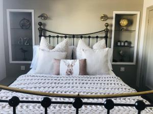 a bedroom with a large bed with pillows at The White Hart Inn in Ingatestone