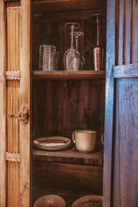 a wooden shelf with plates and bowls on it at Primi Seacastle in Cape Town