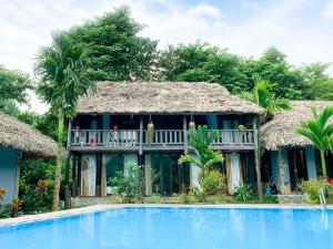 a resort with a swimming pool in front of a building at Mai Chau Sky Resort in Mai Chau