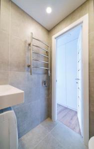 a bathroom with a shower and a toilet and a door at Stylish Studio in Central Vilnius in Vilnius