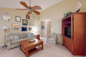 a living room with a couch and a tv at South Hampton --- 37923 Greenwich Ln in Ocean View