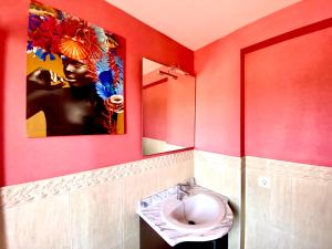 a bathroom with a toilet and a painting on the wall at Casita rural Sierra de Sevilla, combina una maravilla in Seville