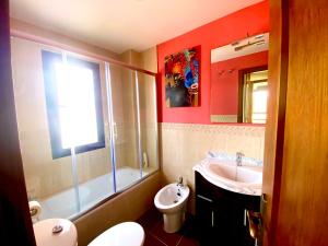 a bathroom with a sink and a toilet and a mirror at Casita rural Sierra de Sevilla, combina una maravilla in Seville