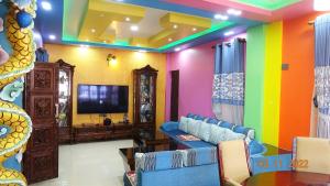 a living room with colorful walls and a tv at Dragon Homestay Bhaktapur in Bhaktapur