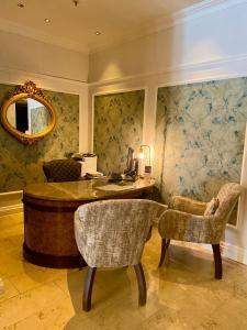 an office with a desk and two chairs and a mirror at Taj HotelApart, Taj Hotel Cape Town in Cape Town
