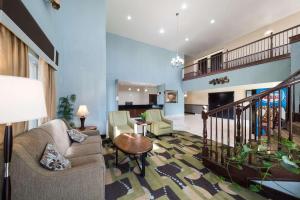 a living room with a couch and chairs and a staircase at Quality Inn and Suites Terrell in Terrell