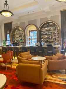 a restaurant with couches and tables and a bar at Taj HotelApart, Taj Hotel Cape Town in Cape Town