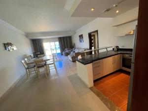 a kitchen and living room with a table and chairs at Palm Resort in Sharm El Sheikh