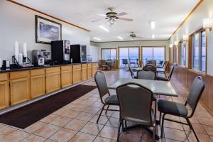 a dining room with a table and chairs at Days Inn & Suites by Wyndham St. Ignace Lakefront in Saint Ignace