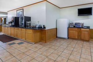 a large room with a kitchen with a refrigerator at Days Inn & Suites by Wyndham St. Ignace Lakefront in Saint Ignace