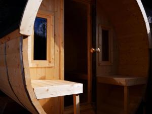 a wooden sauna with a window and a bench at Rinken 9 in Hinterzarten