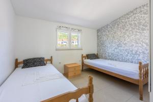 Ένα ή περισσότερα κρεβάτια σε δωμάτιο στο Apartments PERA