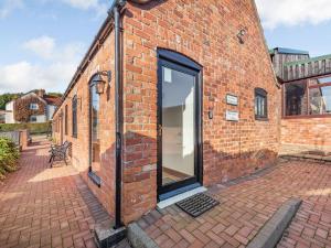 a brick building with a large glass door on it at Betty Hutton - Uk36661 in Goulsby