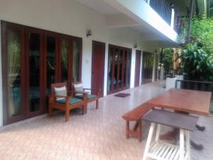 a patio with tables and chairs in a building at LUCKY PAI Resort&Hostel in Pai