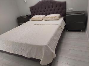 um quarto com uma cama grande e uma cabeceira preta em Apartament Vip Chirie em Chisinau