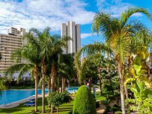 a resort with a pool and palm trees and buildings at Gemelos 22 - Siroco in Benidorm +49 photos