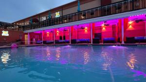 a swimming pool with purple lights in a hotel at Lux Hotel & Spa, Trademark Collection by Wyndham in Arlington
